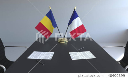 Flags of Romania and France and papers on the table. Negotiations and signing an international 48400899