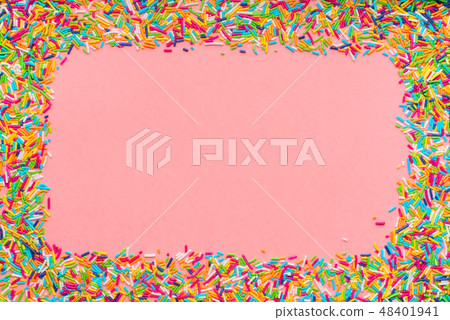 greeting wreath of colorful sprinkles over pink greeting wreath of colorful sprinkles over pink 48401941