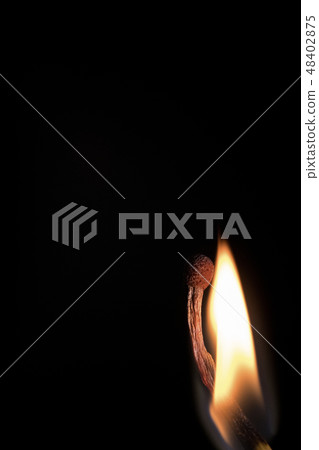 Bright burning match on a black background. 48402875