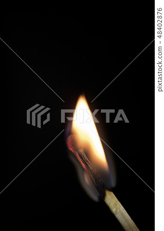 Bright burning match on a black background. 48402876