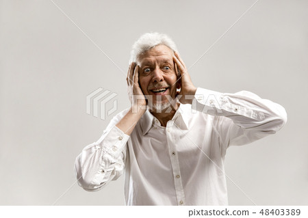The senior man looking suprised isolated on gray 48403389