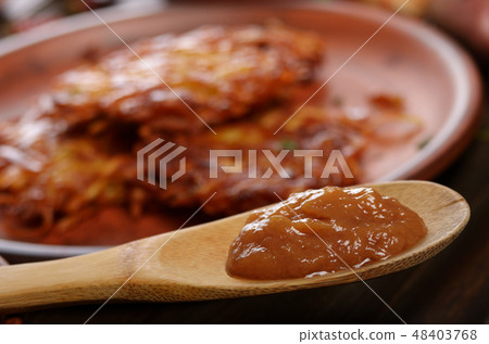 Applesauce in front of fresh homemade tasty potato 48403768