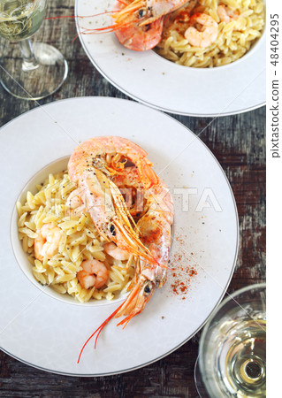 Risoni pasta in risotto with shrimps, white wine Risoni pasta in risotto with shrimps, white wine 48404295