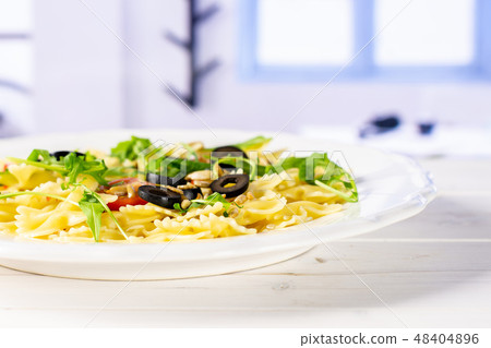 Recipe farfalle with arugula leaves blue window 48404896