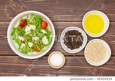 Recipe step by step arugula salad on brown wood Recipe step by step arugula salad on brown wood 48404934