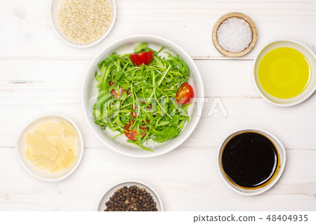 Recipe step by step arugula salad on grey wood Recipe step by step arugula salad on grey wood 48404935