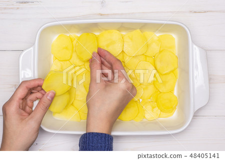 Recipe baked potatoes with onion on grey wood Recipe baked potatoes with onion on grey wood 48405141