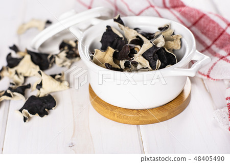 Dry black mushroom jew ear on grey wood Dry black mushroom jew ear on grey wood 48405490