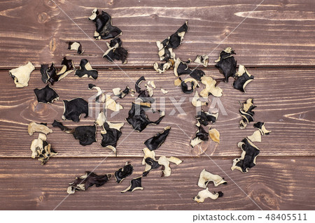 Dry black mushroom jew ear on brown wood Dry black mushroom jew ear on brown wood 48405511