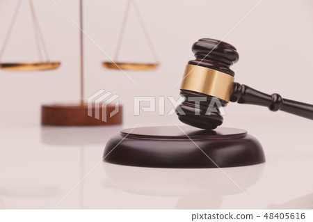 Judge gavel with Justice lawyers having team meeting at law firm in background. Concepts of 48405616