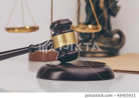 Judge gavel with Justice lawyers having team meeting at law firm in background. Concepts of 48405631