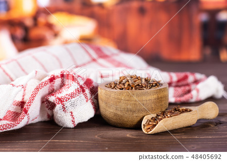 Raw red rice with rustic kitchen 48405692