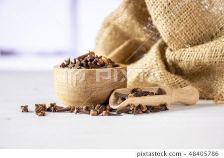 Small dried cloves spice with red tulips Small dried cloves spice with red tulips 48405786