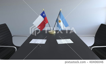 Flags of Chile and Argentina and papers on the table. Negotiations and signing an international 48406046