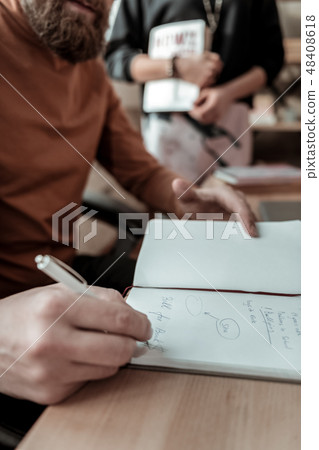 Smart bearded father working in the office and making notes 48408618