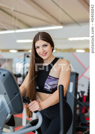 Athletic girl doing an ellipsoid in gym side view Athletic girl doing an ellipsoid in gym side view 48408842