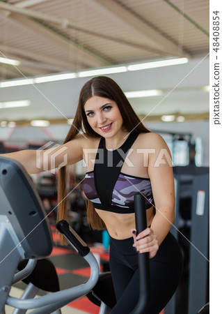 Athletic girl doing an ellipsoid in gym side view 48408854