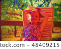 Digital watercolor painting of cute little girl. Girl sitting on garden lounge on verandah 48409215