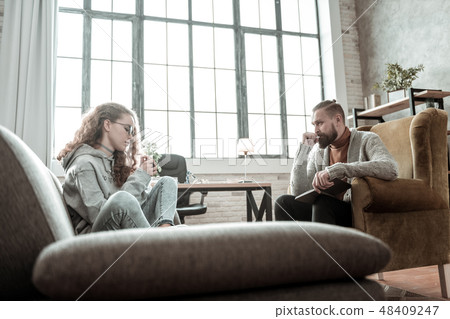 Bearded therapist feeling involved in problem of teenager Bearded therapist feeling involved in problem of teenager 48409247