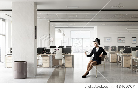 Businesswoman on chair in office 48409707