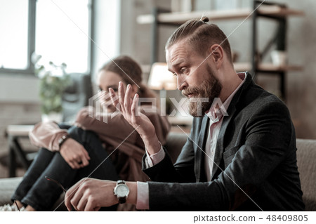 Bearded father trying to calm down his nervous stressed daughter 48409805