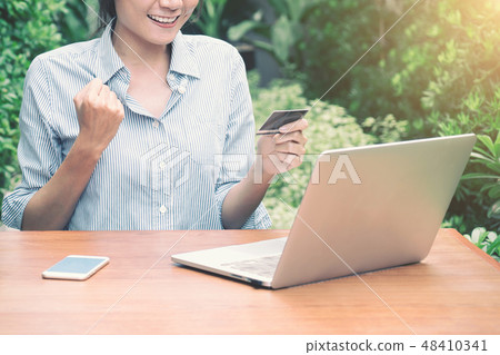 Asian shopper girl buying online with a laptop 48410341
