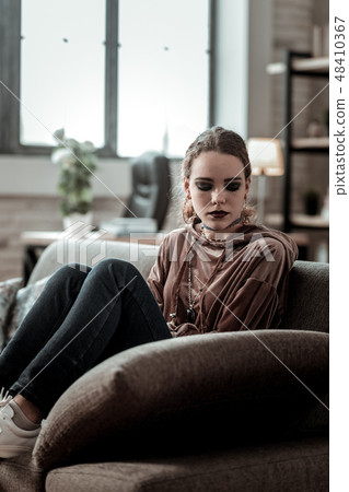 Teenager sitting on sofa feeling very depressed after school 48410367
