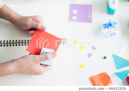 Woman's hand cut paper Making a scrap booking or other festive d Woman's hand cut paper Making a scrap booking or other festive d 48412839