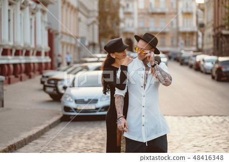 Girl hugging her boyfriend on the street 48416348