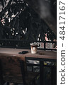 Iced latte and mobile phone on wood bar 48417167