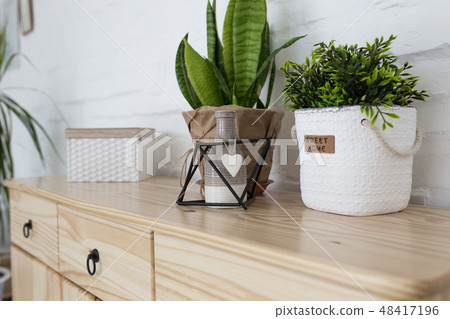 Interior living room with a wooden chest on a white brick wall 48417196