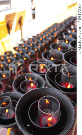 Burning big red candles in Buddhist temple Burning big red candles in Buddhist temple 48417550