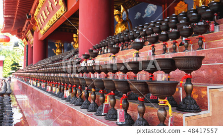 Burning big red candles in Buddhist temple Burning big red candles in Buddhist temple 48417557