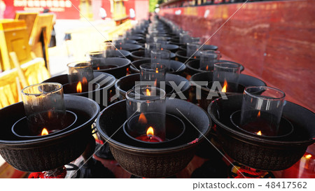 Burning big red candles in Buddhist temple Burning big red candles in Buddhist temple 48417562