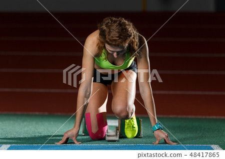 Female athlete on the start at sprint running Female athlete on the start at sprint running 48417865