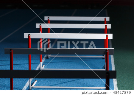 Row of hurdles for sprint training on the lane Row of hurdles for sprint training on the lane 48417879