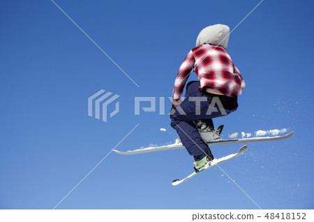 Flying skier at jump inhigh on snowy mountains Flying skier at jump inhigh on snowy mountains 48418152