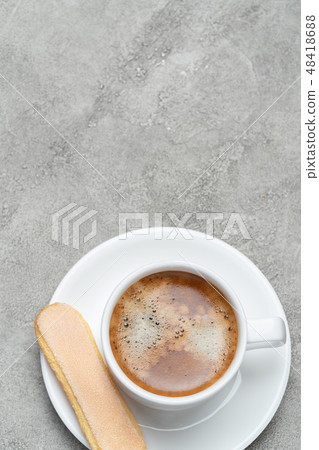 Italian Savoiardi ladyfingers Biscuits and cup of coffee on concrete backgound Italian Savoiardi ladyfingers Biscuits and cup of coffee on concrete backgound 48418688