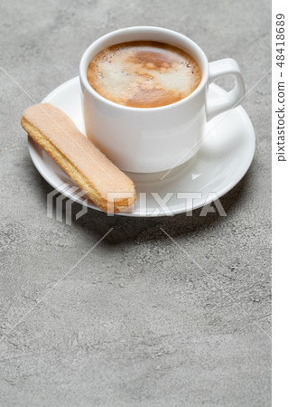 Italian Savoiardi ladyfingers Biscuits and cup of coffee on concrete backgound Italian Savoiardi ladyfingers Biscuits and cup of coffee on concrete backgound 48418689