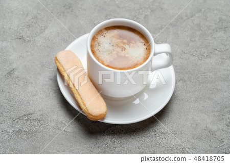 Italian Savoiardi ladyfingers Biscuits and cup of coffee on concrete backgound 48418705
