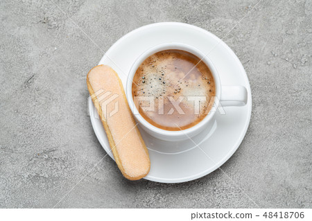 Italian Savoiardi ladyfingers Biscuits and cup of coffee on concrete backgound Italian Savoiardi ladyfingers Biscuits and cup of coffee on concrete backgound 48418706