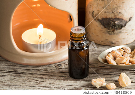 A bottle of styrax benzoin essential oil and resin A bottle of styrax benzoin essential oil and resin 48418809