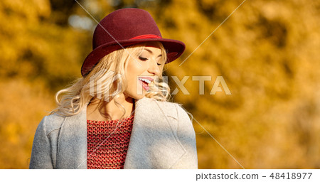 Beautiful elegant woman standing in  autumn park 48418977