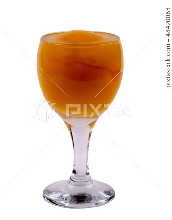 glass with a peach on a white background, side vie 48420063