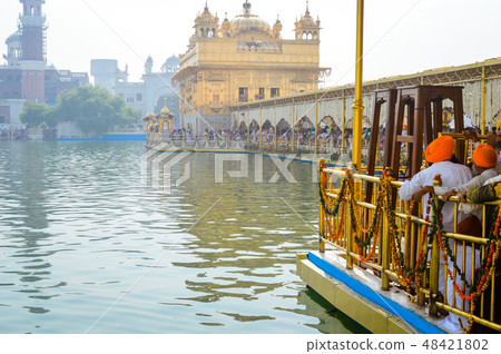 People standing in Golden Temple Amritsar, India. People standing in Golden Temple Amritsar, India. 48421802