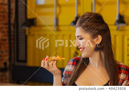 Beautiful and sexy girl sitting by the window in a 48423926