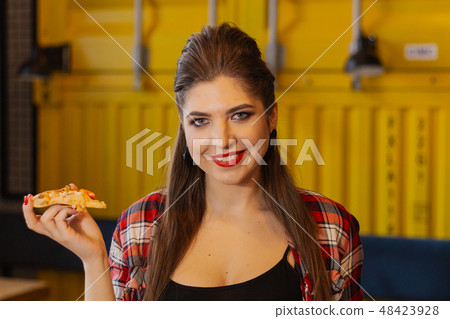 Beautiful and sexy girl sitting by the window in a 48423928