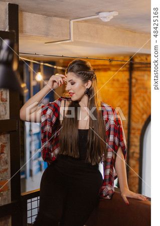 Beautiful and sexy girl posing in a cafe. Loft 48425168