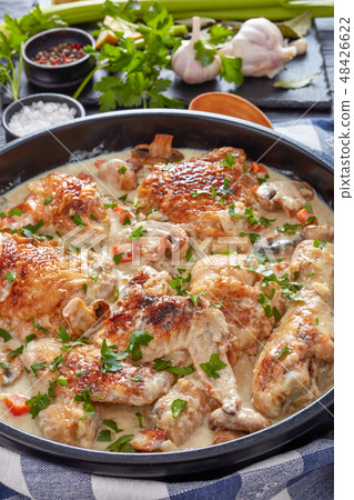 hot chicken fricassee in a black saucepan hot chicken fricassee in a black saucepan 48426622