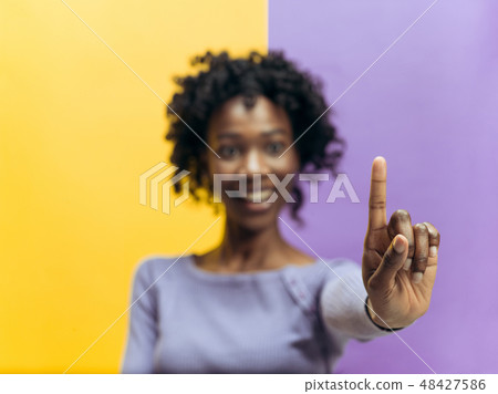 Woman's hand with finger on blue background 48427586